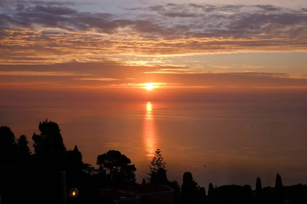 Sunrise over the Ionian Sea, view from the hotel balcony in Taormina