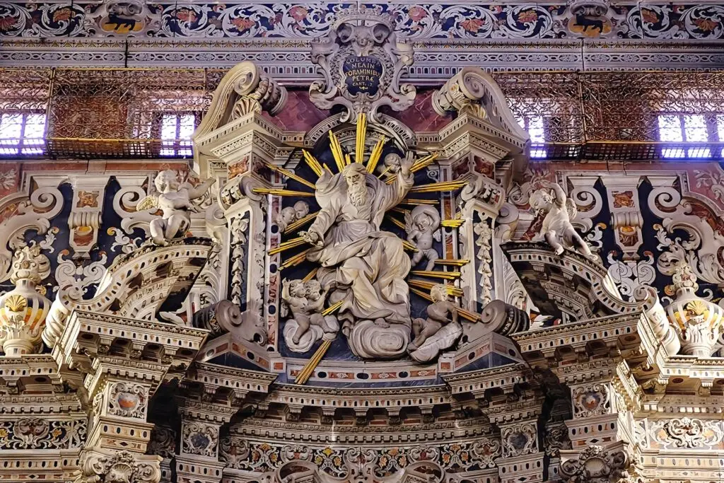 Baroque marble sculpture with gold rays and cherubs inside the Church of Saint Catherine of Alexandria in Palermo