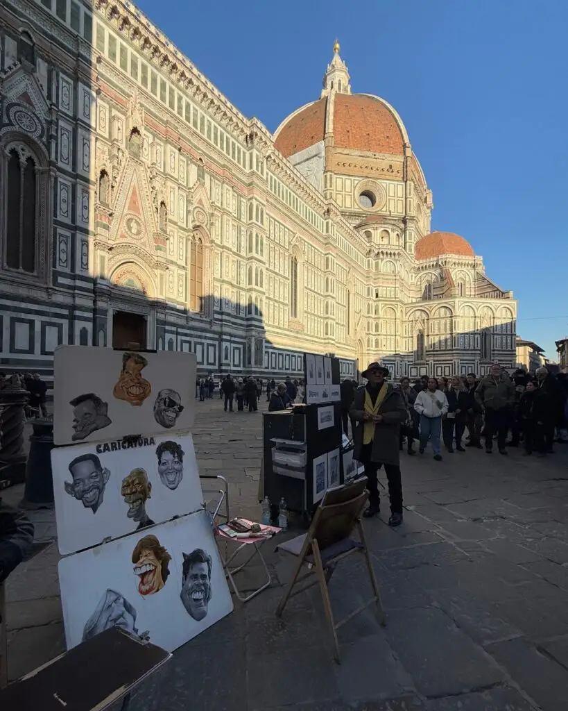Street artists selling paintings with Florence Cathedral in the background