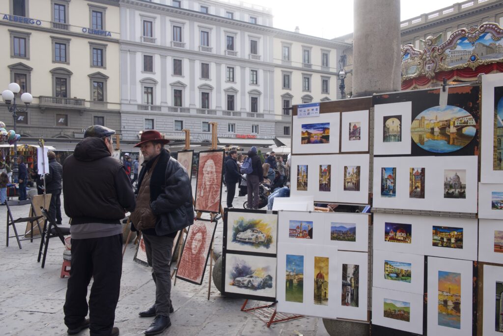 Street artists selling paintings near Florence Cathedral