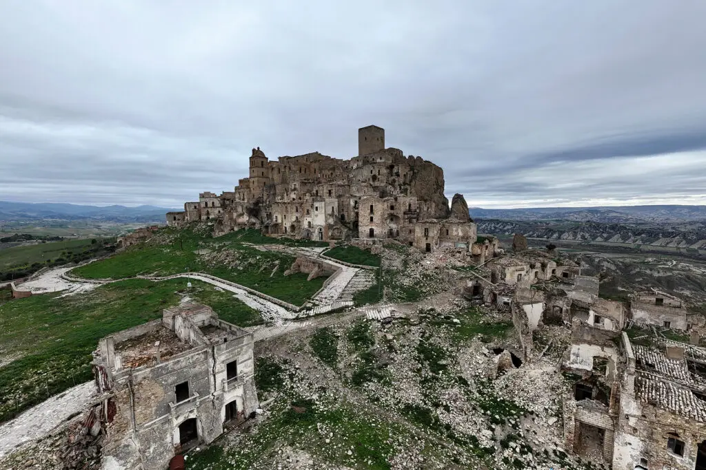 Abandoned stone buildings and ruins in Craco Vecchia seen from above