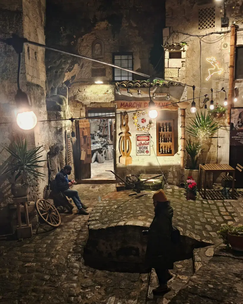 Arte Pastorale workshop illuminated at night in Matera