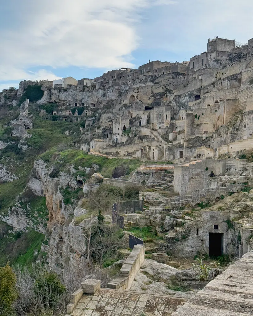 Ancient cave dwellings carved into the rocky side of the Gravina di Matera