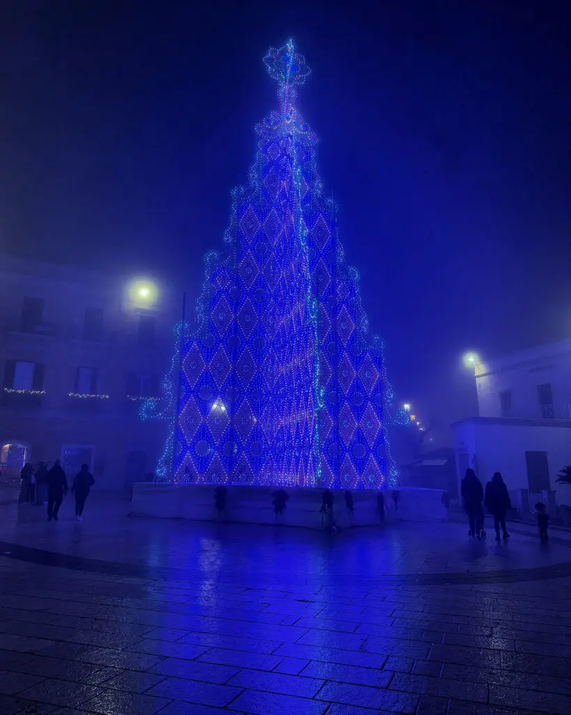 Illuminated Christmas tree outside Chiesa di San Biagio in Matera at night
