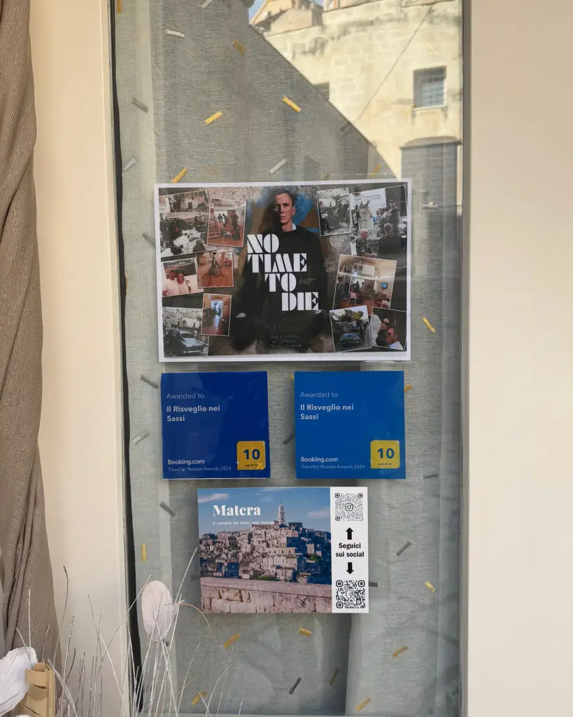 No Time to Die filming display on the door of a tour office in Matera