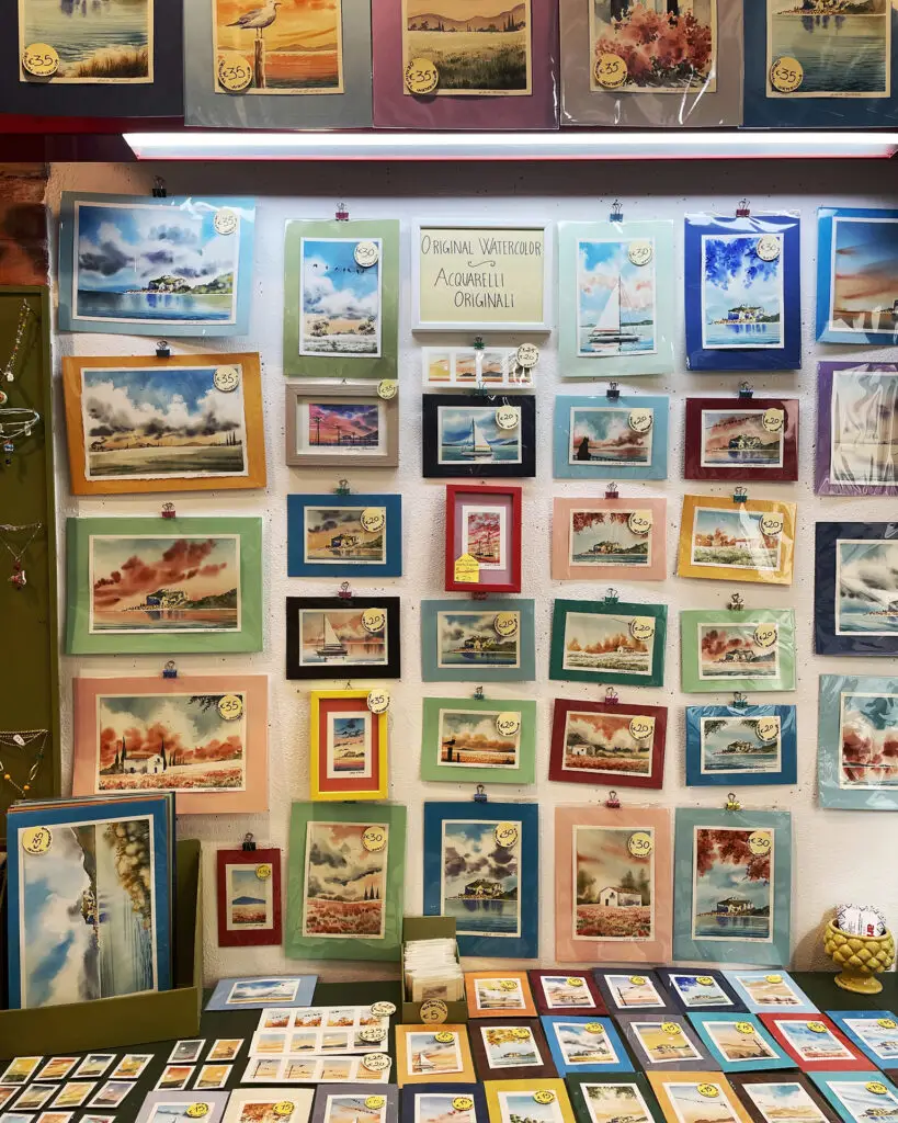 Tiny watercolour paintings of Cefalù displayed inside SiciliaDipinta art studio